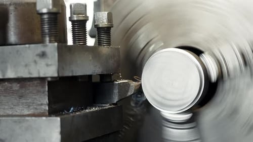 Close-up shot processing of the metal part on the lathe, the lathe processes the edge of the metal