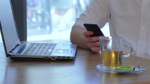 Close Up of Male Hand Holds the Smartphone