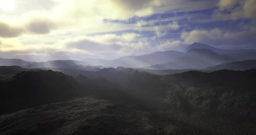 Expansive Mountain Landscape with Soft Sunlight and Distant Peaks at Dawn