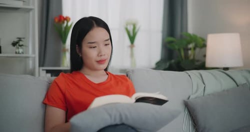 Woman Relaxing at Home Reading a Book