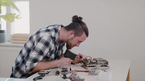 Young Man at Repair Cafe Repairing Household Electrical Devices