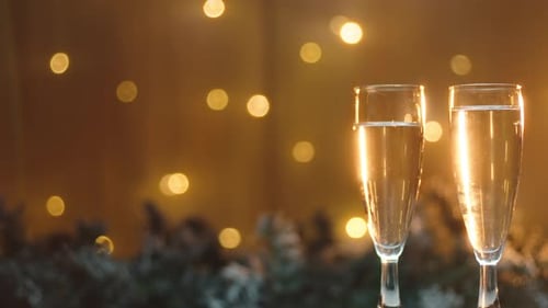 Festive Champagne Glasses with Golden Christmas Lights