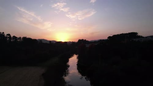 Aerial View of Misty River at Sunset