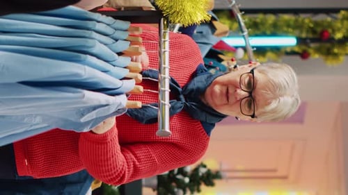 Senior Woman Browsing Shirts in Decorated Apparel Store