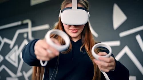 Woman Plays Virtual Reality Game with Headset