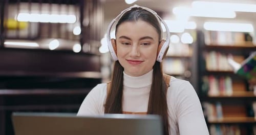 Student, music and woman on laptop in library typing for education, university and knowledge