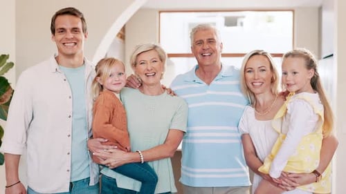 Multigenerational Family Smiles Happily Inside Their Home