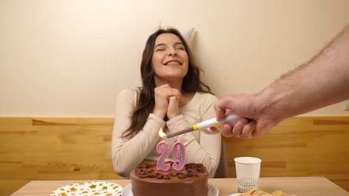 Woman Celebrates Birthday, Makes Wish and Blows Candles