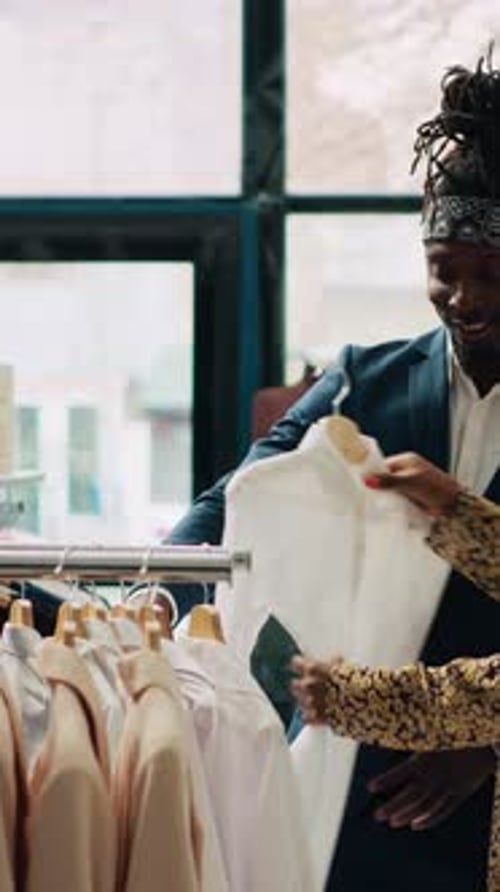 Stylish Shoppers Browse Rack of Clothes in Shop