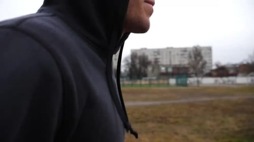 Young Sportsman Jogging on School Stadium at Cloudy Day Athletic Sporty Man Running on Athletic
