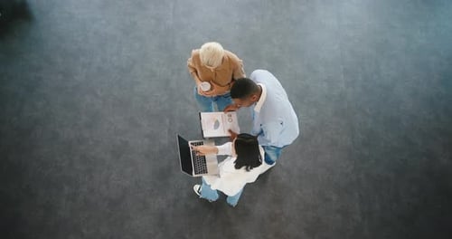 Diverse Team Collaborating on Project in Modern Office