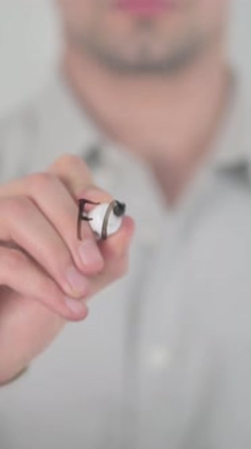 Man Writes "Fast Business" on Glass Surface