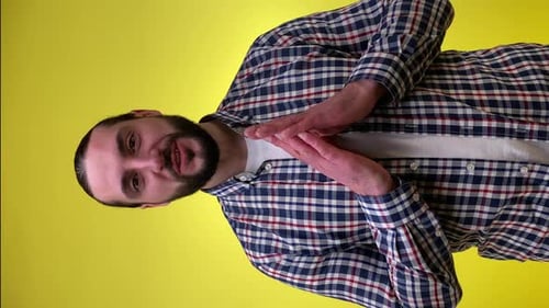 Man Talking and Gesturing on Yellow Background