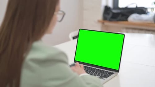 Rare View of Business Woman Using Laptop with Green Screen