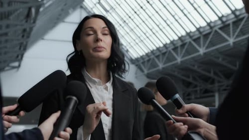 Business leaders discuss finance at press conference in modern office center