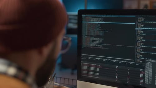 Man Coding at Computer Workstation