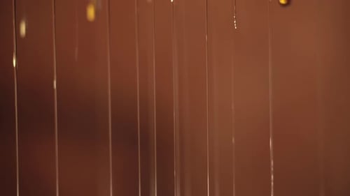 Golden Liquid Slowly Dripping Down