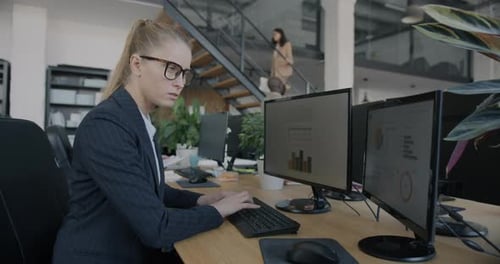 Young Woman Company Manager Working with Computer Typing Concentrated on Job at Desk in Coworking