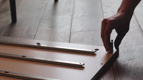 Close Up Hand Twists A Screw And Starts Building A Shelf