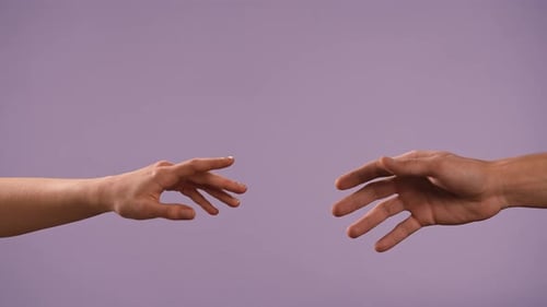 Man and Woman Hands Showing Gestures and Touching Crossing Fingers Isolated on Purple Studio