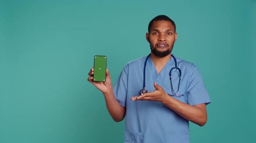 Friendly Doctor Presenting Medical Information on Phone