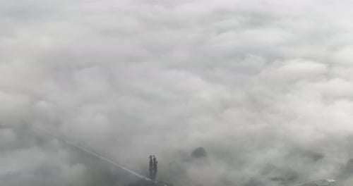 Aerial Drone Footage of Misty Fog Blowing Over Pine Tree Forest on a Beautiful Morning