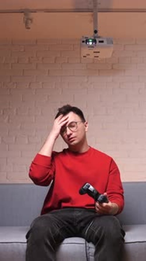 Man Playing Video Game Looking Stressed Indoors
