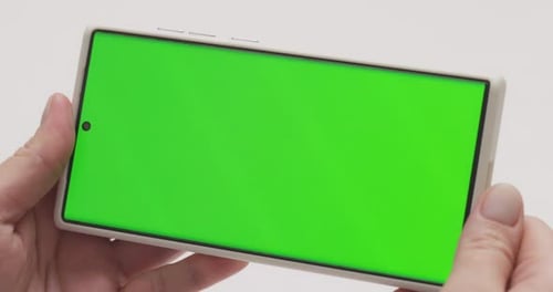 Closeup of Woman Hands Holding Smartphone with Green Screen