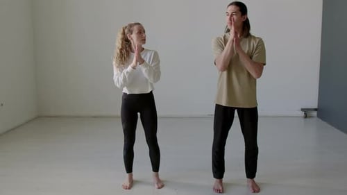 Couple of Dancers Warming Up and Doing Wrist Stretch in Studio
