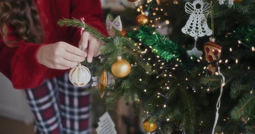 Child Decorating Beautiful Christmas Tree at Home