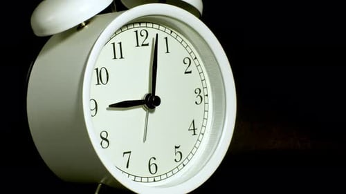 Tme lapse video of a clock time passing over a day to night on black background.