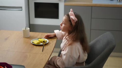 Slow Motion The Girl Has Lost Her Appetite As She Cuts a Pancake with a Dessert Knife While Sitting