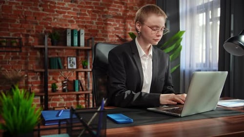Focused Businesswoman Considering New Strategic Opportunities at Her Desk