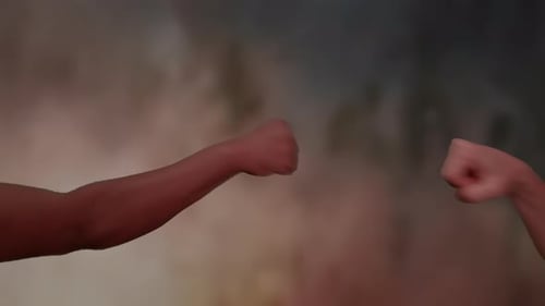 Close Up Fist Bump in Front of Blurred Background