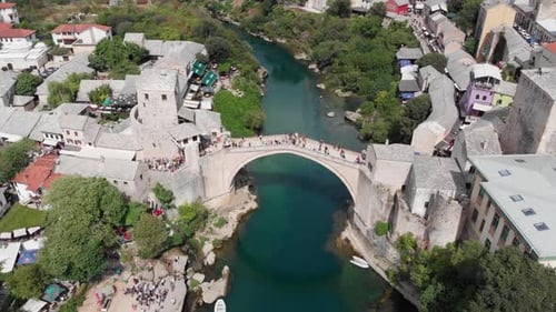 Aerial: drone flying over the Stari Most in Mostar in a sunny day