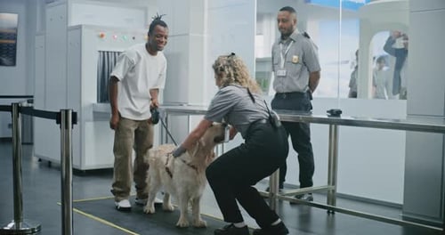 Man with Pet During Screening Procedures in Airport Terminal Female TSA Officer Scanning Dog