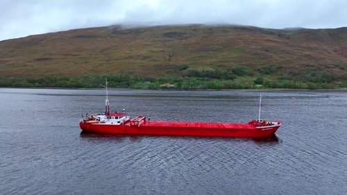 Bright Red Cargo Ship on Open Water