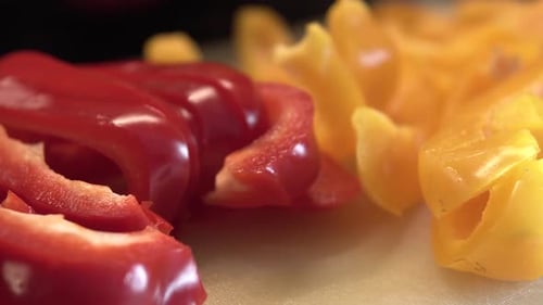 Sliced Red and Yellow Bell Peppers on Cutting Board