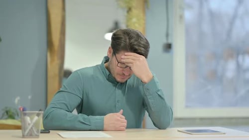 Man at Desk Experiencing Headache or Stress