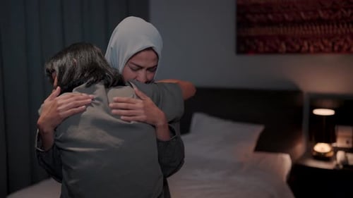 Two Women Sharing a Loving Embrace Indoors