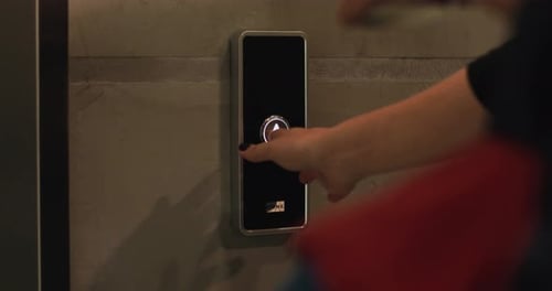Close Up Hand Young Woman Presses a Button of Lift to Go Up By a Finger with a Painted Nail Elevator