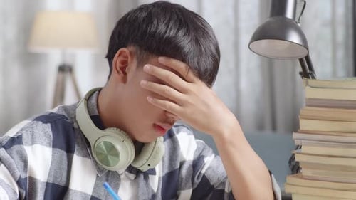 Tired Teenager Having Headache While Learning At Home