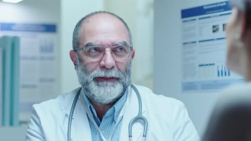 Senior Doctor Consulting Patient in Clinic