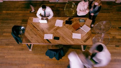Business people around a table at a meeting, high angle view, time lapse fast
