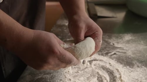 Chef Prepares Dough Ring on Floured Surface