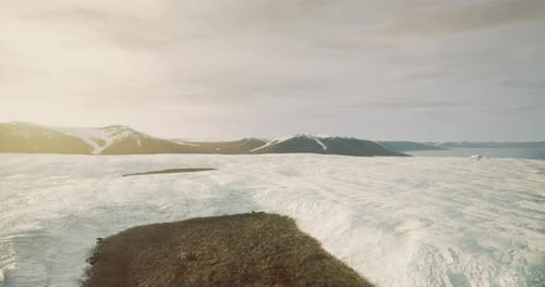Aerial View of Snow-Covered Mountains and Rocky Landscape