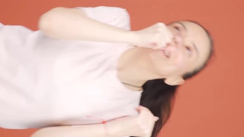 Woman playfully punching face in portrait video