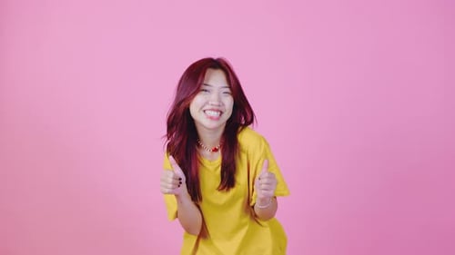 Smiling Woman Gives Two Thumbs Up Approval