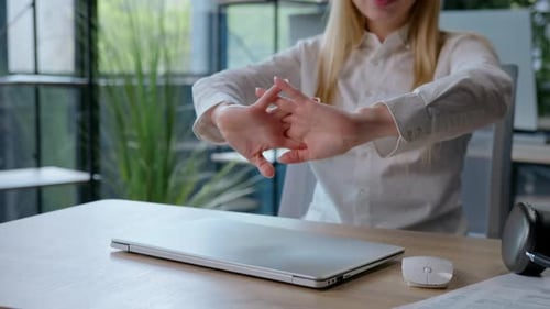 Satisfied Caucasian Businesswoman Completing Working with Laptop Stretching Hands Listen Music in
