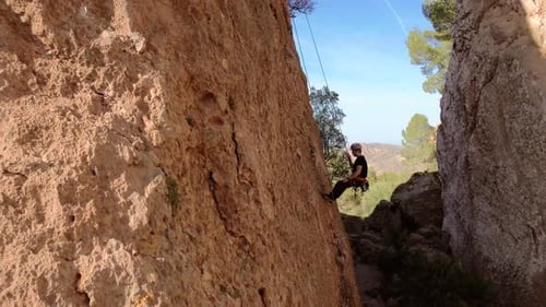 Man rock climbing aerial view of sportsman rapelling mountain in La Panocha, el Valle Murcia, Spain
